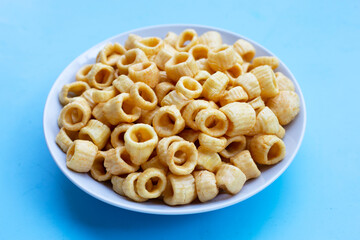 Crispy potato rings on blue background.