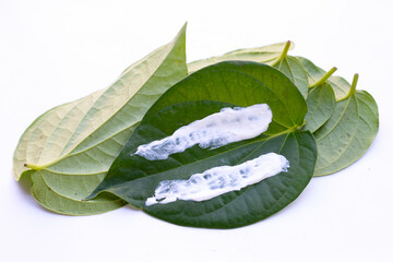 Chewing betel nut, cal lime powder on betel leaves