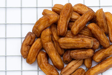 Sun-dried bananas on white background.