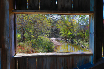 Scenes from Grafton, Vermont through the window of a covered bridge make this beautiful place scenic and historic as the creek passes below