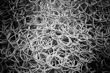 Close up of tangled wires in black and white.