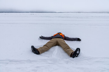 Snow angel on Gunflint Lake in Northern Minnesota on the Canadian Border edge of the Boundary Water...