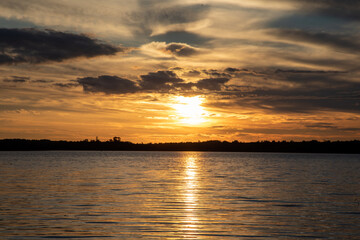 Obraz premium Beautiful sunsets at the lake cabin in Northern Minnesota remind us of the beauty in nature when we travel and explore vacation resorts and remote wilderness areas