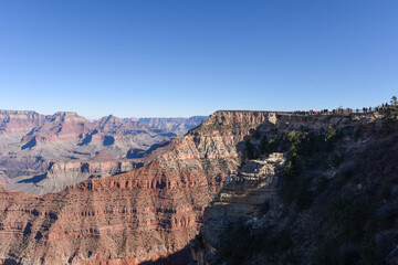 People standing on the rim of the Grand Canyon.