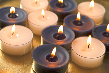 Fototapeta na wymiar Candle flame.White and blue burning candles .Candles background. Zen and relaxation concept.
