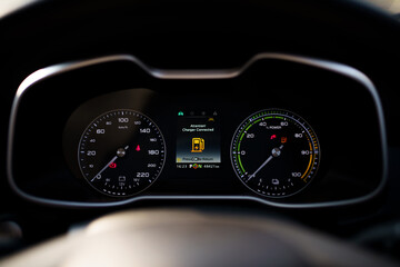 Digital modern dashboard in a electric vehicle - EV while charging at the charging station.