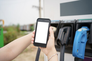 Empty screen of mockup smartphone isolated with clipping path. Asian young woman using ev charging application on smartphone.