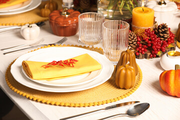 Autumn table setting with floral decor and pumpkins indoors