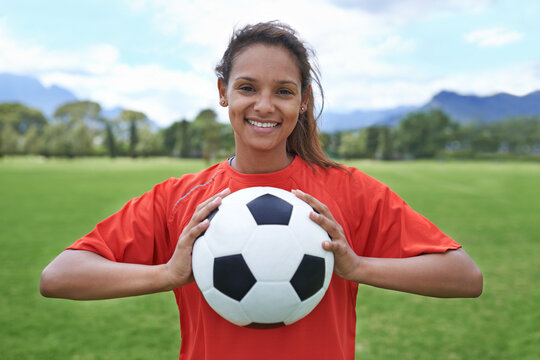 In it to win. Shot of a young female soccer player holding a soccer ball.