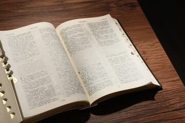 Open Bible on wooden table. Christian religious book