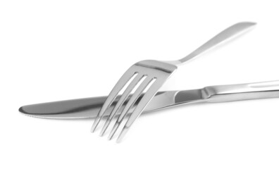 Shiny fork and knife on white background