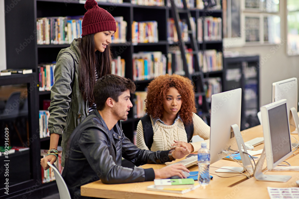 Poster This study group knows what theyre doing. Shot of a group of students working together at a computer in a university library.