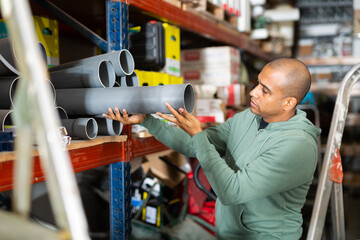 Latin american man choosing materials for overhauls in building materials store