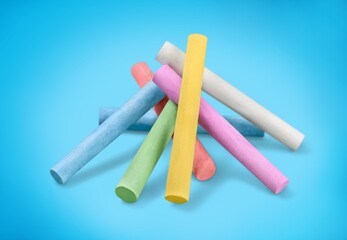 Stack of colored chalk on background