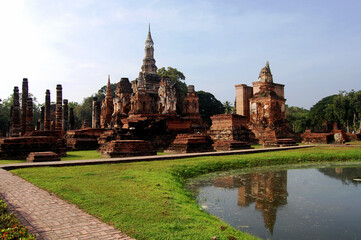 Fototapeta na wymiar Ancient antiquity architecture and antique ruins building for thai people travelers travel visit respect praying at Si Satchanalai Historical Park and Unesco World Heritage Site in Sukhothai, Thailand