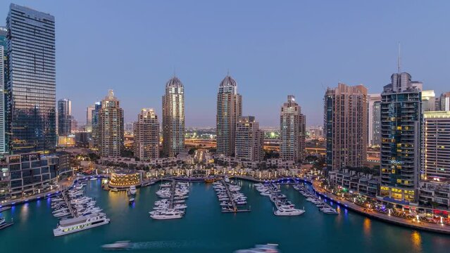 Dubai Marina skyscrapers aeral day to night timelapse, port with luxury yachts and marina promenade