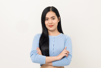 Obraz premium Portrait of Young beautiful Asian woman standing and smiling isolated on white background. Cheerful female age around 20 wearing a blue shirt Looking at camera in white studio