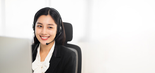 Call centre female operator. Smiling asian business woman receptionist wearing headphone video conference calling talk by webcam in online chat customer support service.