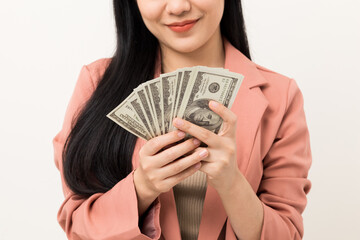 Cheerful young Asian business woman showing lot of money. Attractive female with dollar banknotes. Happy asian woman  counting money us dollar Financial business concept on isolated white background