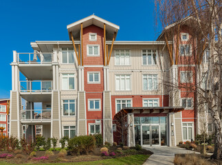 Brand new apartment building on sunny day in BC, Canada. Architectural details of modern apartment...