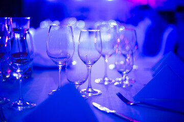 Wine glasses in the restaurant. Soft blue light and depth of field create an amazing atmosphere