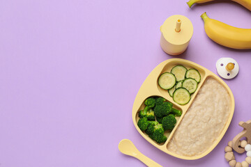 Healthy baby food in plate and accessories on violet background, flat lay. Space for text