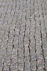 road paved with gray cobblestones. natural stone parquet.

