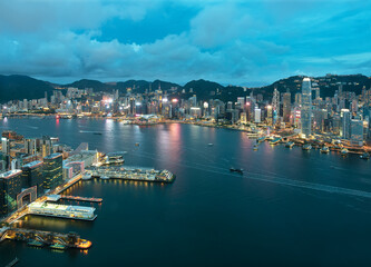 Aerial view of Victoria Harbor of Hong Kong city at dusk