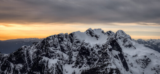 Aerial Panoramic View of Canadian Rocky Mountain Landscape. Cloudy Sunset Sky. Located near Vancouver, British Columbia, Canada. Nature Background Panorama