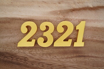 Golden Arabic numerals on a real brown and white wooden floor number 2321