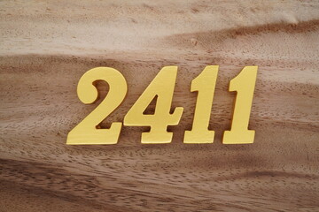 Golden Arabic numerals on a real brown and white wooden floor number 2419