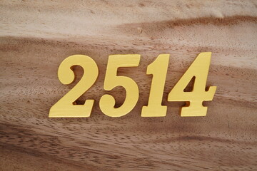 Golden Arabic numerals on a real brown and white wooden floor number 2514