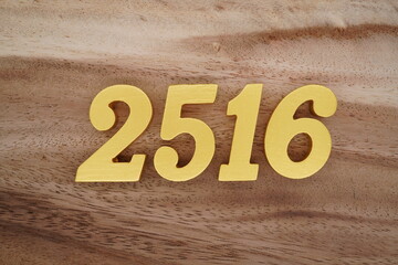 Golden Arabic numerals on a real brown and white wooden floor number 2516