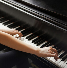 Obraz premium Reaching for the right notes. Cropped shot of hands on piano keys.
