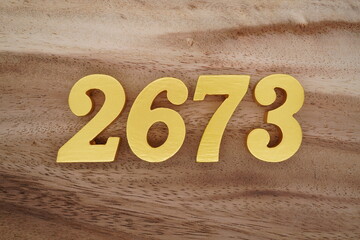 Golden Arabic numerals on a real brown and white wooden floor number 2679