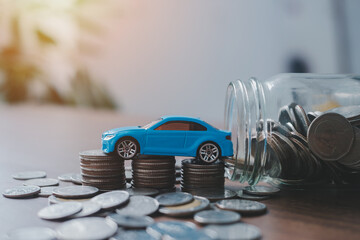 Saving money for a car or material design concepts. Miniature car model and Financial statement...