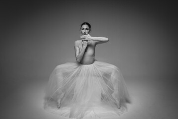 classic black and white portrait, young pretty, fragile, beautiful ballerina dancing in a long pale...