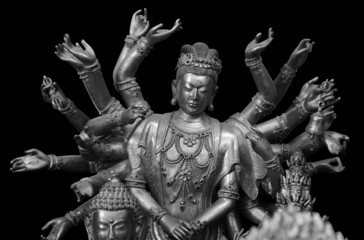Multi armed Shiva statue isolated on black background with clipping path. Buddha statue with many...