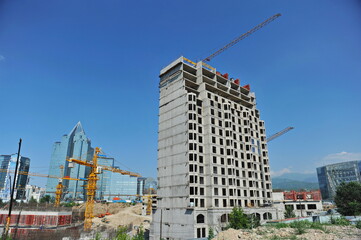 Almaty / Kazakhstan - 07.02.2012 : Dense development of houses in the city center: construction of a residential complex close to other objects.
