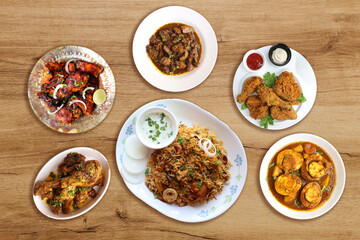 Assorted Indian chicken dishes. Nonveg food banner. Chicken fry, Tandoori, Biryani, Fried chicken, Liver masala, egg curry, bhurji, fried egg. food items over black background with copy space. 