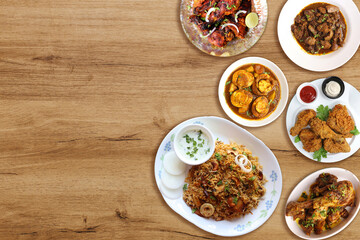 Assorted Indian chicken dishes. Nonveg food banner. Chicken fry, Tandoori, Biryani, Fried chicken, Liver masala, egg curry, bhurji, fried egg. food items over black background with copy space. 