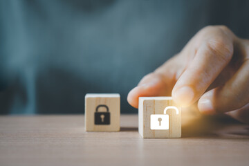 senior woman's hand choose wooden cubes with red unlocked key  for finding solutions concept....