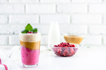 Delicious layered yogurt dessert with applesauce, raspberries and banana.