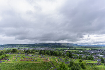Fototapeta na wymiar Scenery from Stirling Castle viewing Old Town Cemetery and The National Wallace Monument very far away in Stirling , Scotland