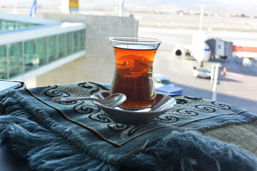 Istanbul / Turkey - 02.23.2017 : Black tea in a traditional glass glass on the background of the city's airport
