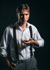 Man holds glass brandy. Young man drink cognac. Man holding a glass of whisky.