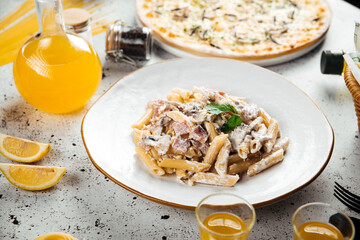 Top view on italian pasta with ham and mushrooms
