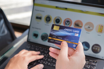 Woman holding credit card on laptop. shopping online payment concept.