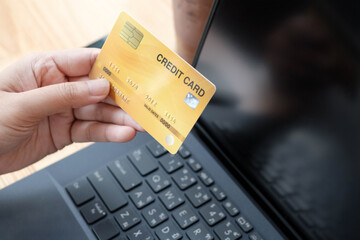 woman using a credit card for online shopping on website.