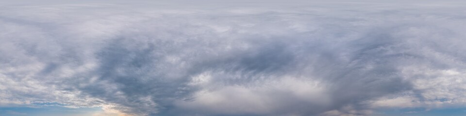 Overcast sky panorama on sunset with Cumulus clouds in Seamless spherical equirectangular format as full zenith for use in 3D graphics, game and aerial drone 360 degree panoramas for sky replacement.